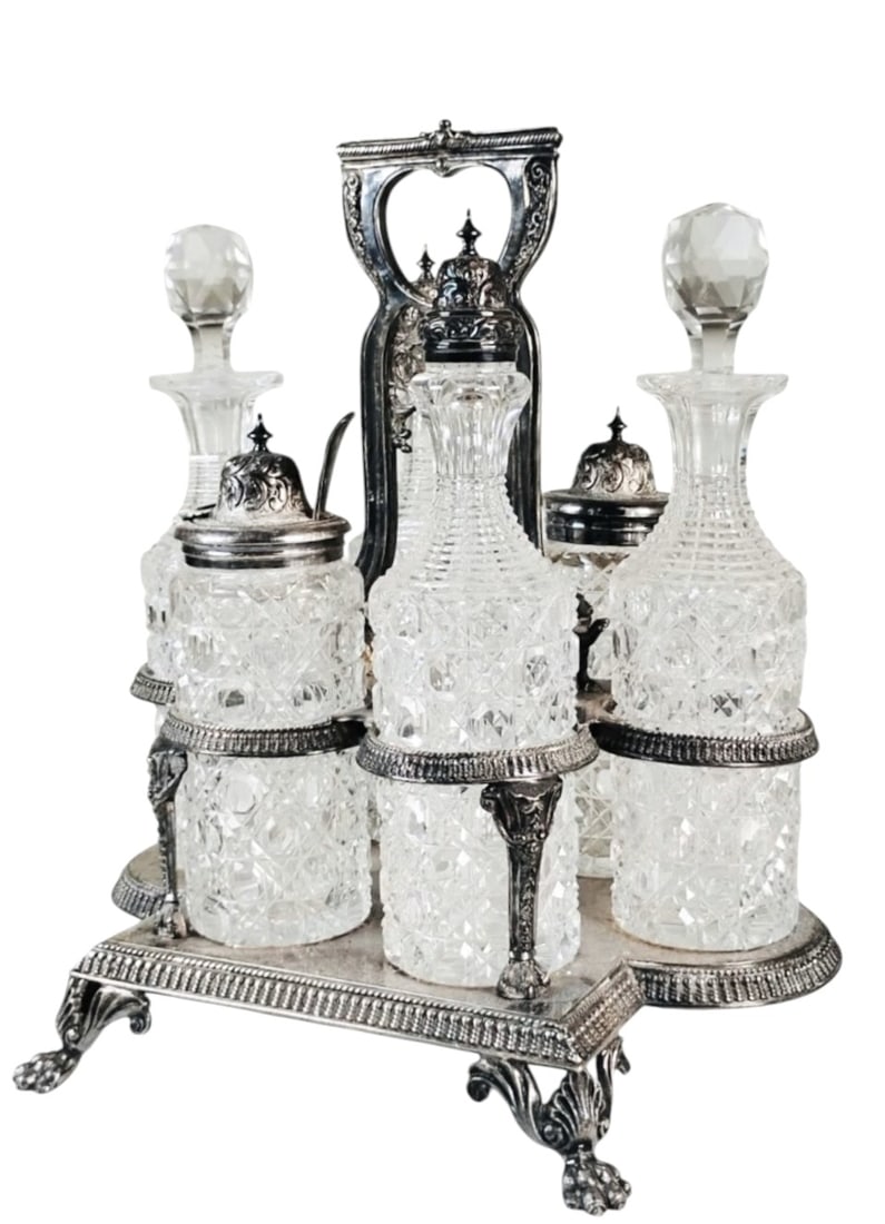 Cut Glass Victorian Cruet Set, Circa 1890: Exceptional Victorian silverplate cruet set with 6 cut glass bottles and stoppers. Very good condition. Dimensions: H. 11 inches W. 10 inches D. 8 inches
