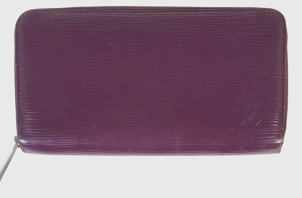 Louis Vuitton Monogram Mahina Leather Wallet: Louis Vuitton women's monogram Mahina leather "zippy" wallet. Very good condition. Dimensions: 8 x 4 1/2 x 1 inches