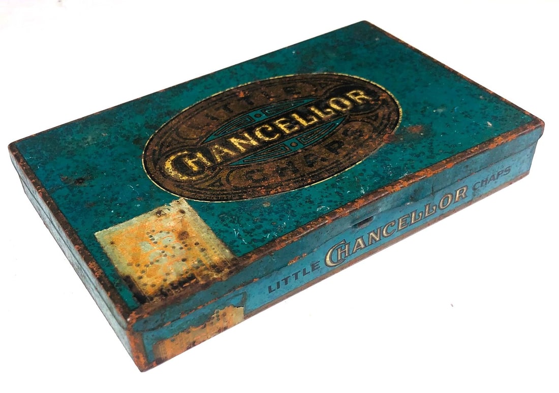 Little Chancellor Chaps Cigar Tin: Vintage cigar tin, Little Chancellor Chaps, circa early 20th century. Wear commensurate with age and use. Dimensions: L. 7 inches W. 4 1/4 inches H. 1 inch