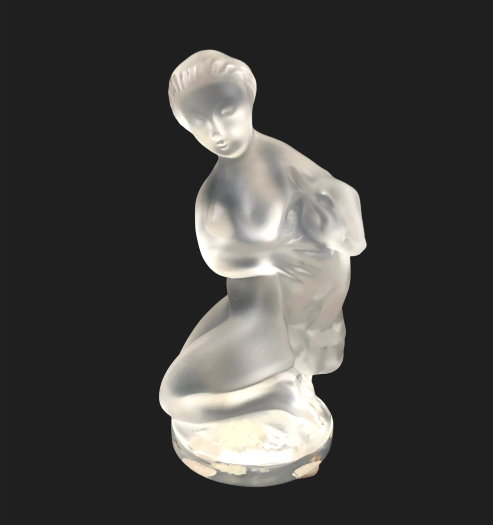 Lalique Crystal Figure, Woman With A Goat: Lalique table sculpture, kneeling (nude) woman holding a goat, in clear and frosted crystal. Signed, circa mid-late 20th century. Very good condition. No damage noted. Dimensions: H. 4 3/4 inches W. 2