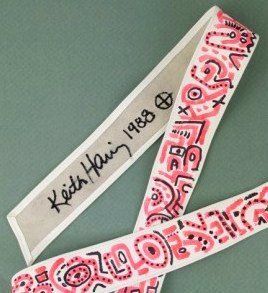 Keith Haring (1958-1990) Decorated Belt: Very unusual white leather belt completely decorated in red and black marker pen by Keith Haring (1958-1990). Signed on the front of the belt and also fully signed and dated (1988) on the reverse. Ver