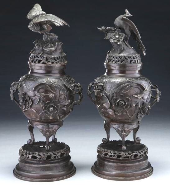 Japanese Meiji Bronze Censors, 19th Century: Fine pair of Japanese Meiji period patinated bronze censors with lids mounted with birds, the urns further decorated with fauna and flora. H. 19 3/4 inches. Circa 3rd or 4th quarter 19th century.