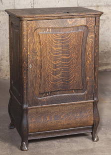 National Cash Register Stand: Antique oak cash register stand with five divided drawers, three open drawers and supply cabinet on bottom with hinged door. Resting on scalloped legs with brass mounts. Original brass and iron