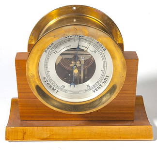 Chelsea Ship  Barometer: Round brass barometer resting on wood base. Barometer includes change of direction on dial and rain, fair, stormy and very dry. Holosteric Barometer. Working condition, No key. 11 1/4w x 6d x 10h