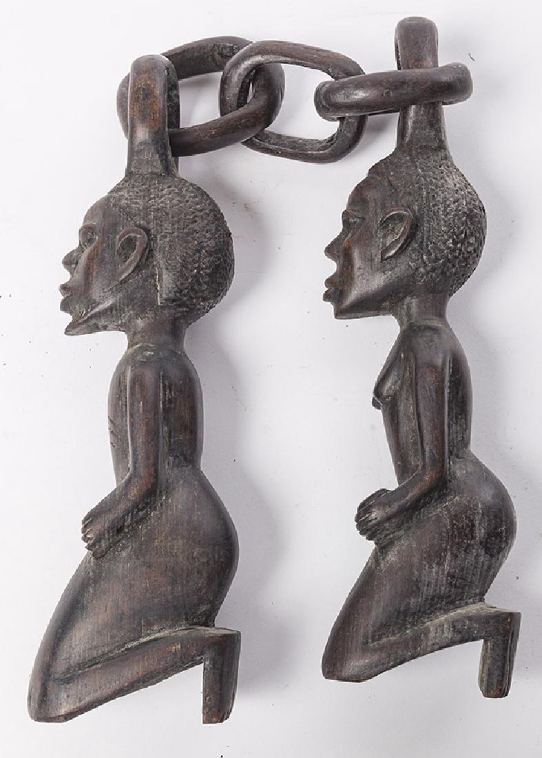African Figural Weapon: Carved Nunchaku style weapon with wooden chain links and figures. 30 1/2w x 3d x 3 3/4h