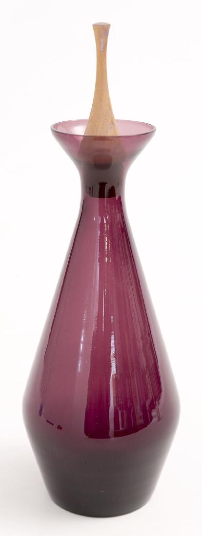 Raymor Decanter: Slender decanter with flared top. Denmark, 1960's Manufacturer's label to underside. Glass, teak 4 dia x 13h