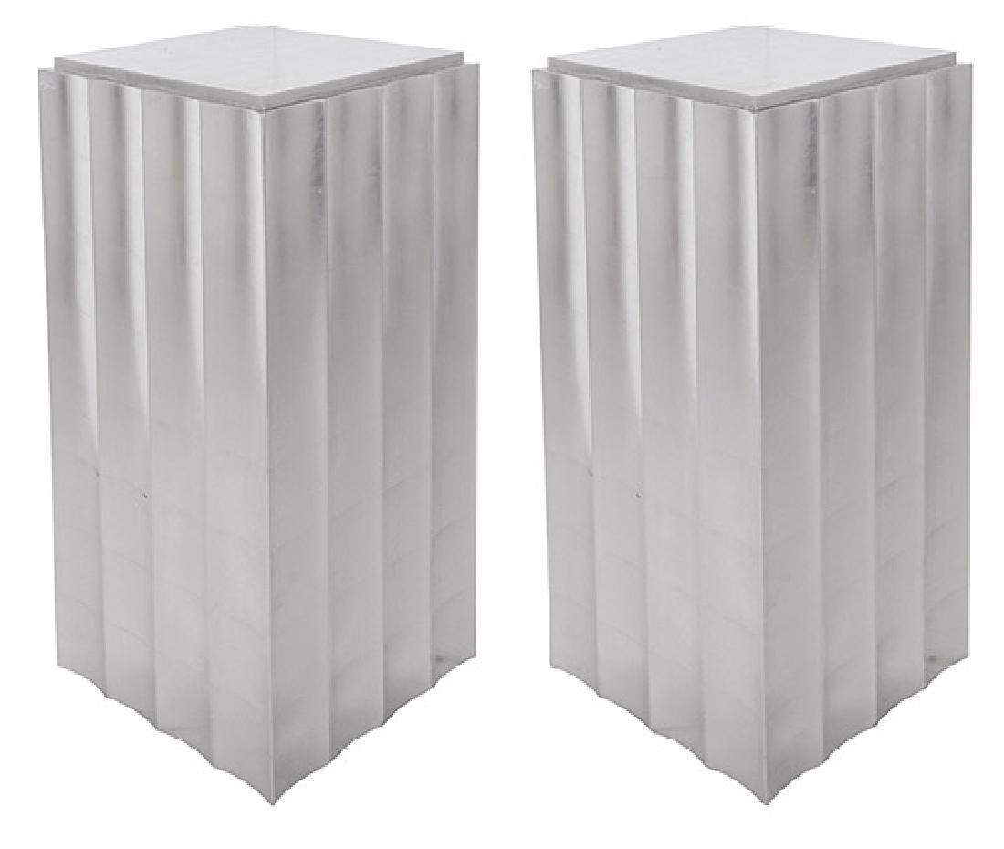 In the manner of Samuel Marx Pedestals: Ribbed pedestals, pair. 1960's. Silver leaf over wood. 16 1/4w x 16 1/2d x 42 1/4h.