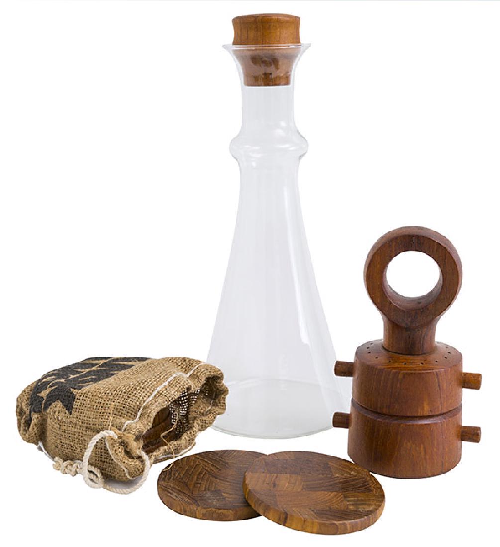 Jen Quistgaard Grouping: Peppermill, coasters, and wine decantor carafe. Dansk. 150's and 1970's. Manufacturer's mark to each coaster along with origianl knit manufacturer's sack. Peppermill; 4 1/4w x 3 1/4d x 7h, coasters; 4
