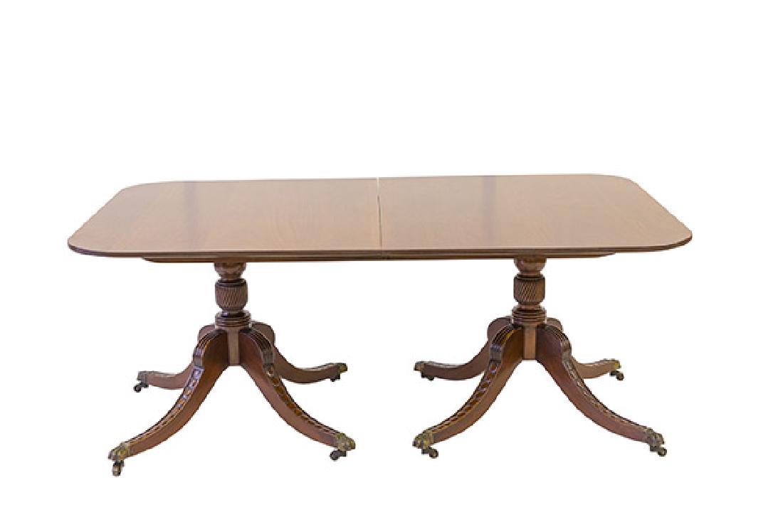 Fine 19th Century Mahogany Dining Table: Mahogany dining table with two Duncan Phyfe style legs supporting a turned baluser column. Three inch leaves. Table and leaves have a matched ribbed border. Legs have unusual decorative molding and re