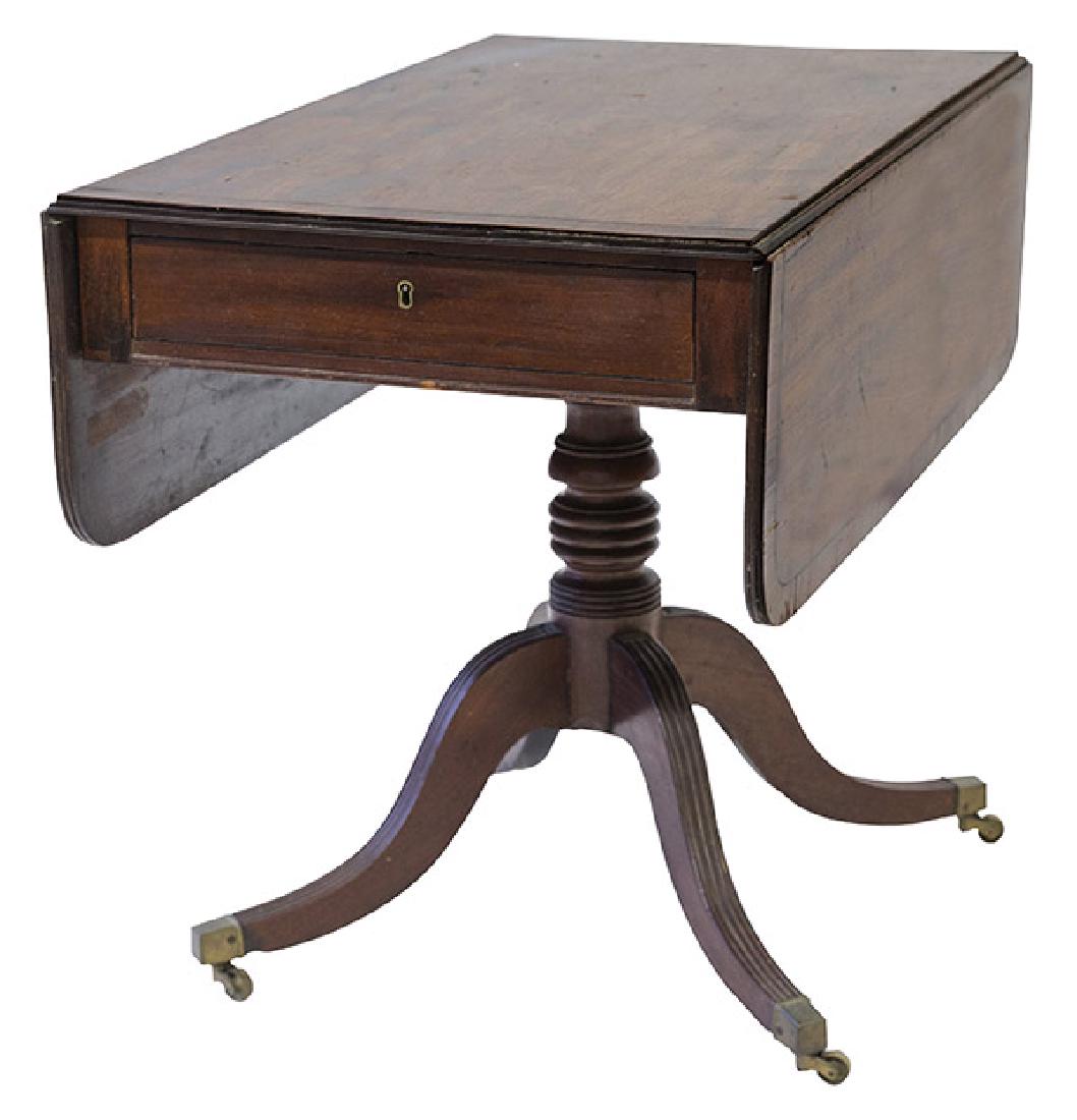 19th Century Pedestal Pembroke Table: Mahogany, circa 1820-1840, one drawer, drop sides resting on turned pedestal on a duncan phyfe style base with original brass castors.