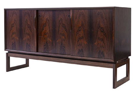 Henning Norgaard Rosewood Credenza: Credenza. Komfort, Denmark, 1970. Rosewood. Cabinet has three doors concealing three drawers and storage. 59w x 18 1/2d x 32h.