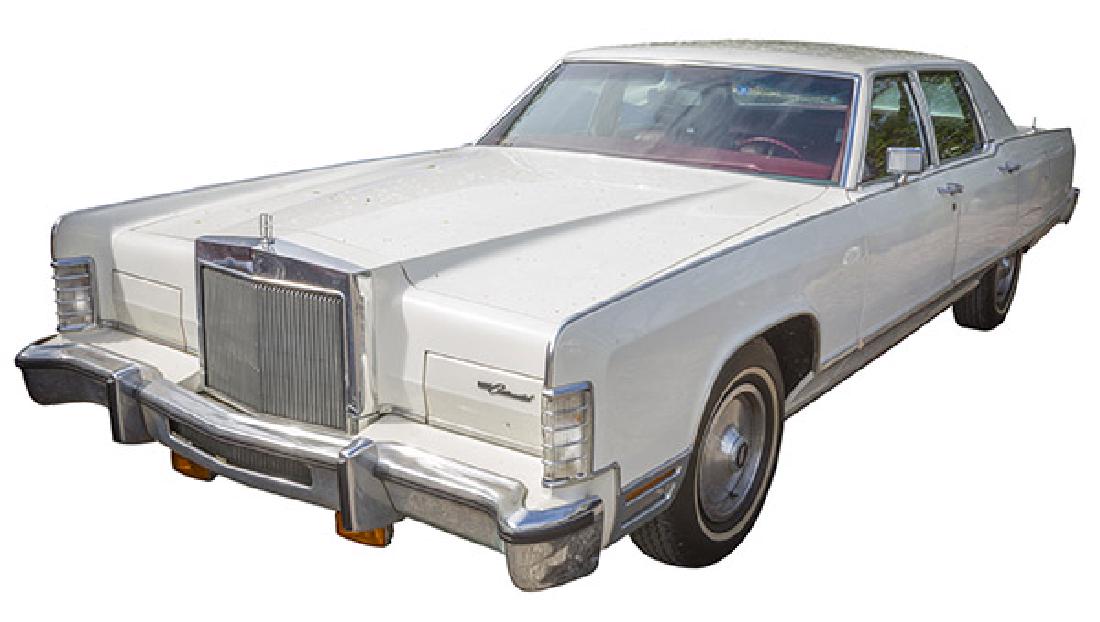 1977 Lincoln Continental Town Car: All original. White exterior with maroon interior. Cold factory air conditioning. Factory turbine wheels and older white wall radial tires. Garage kept, pampered and serviced. Rust free. 25,000 miles.