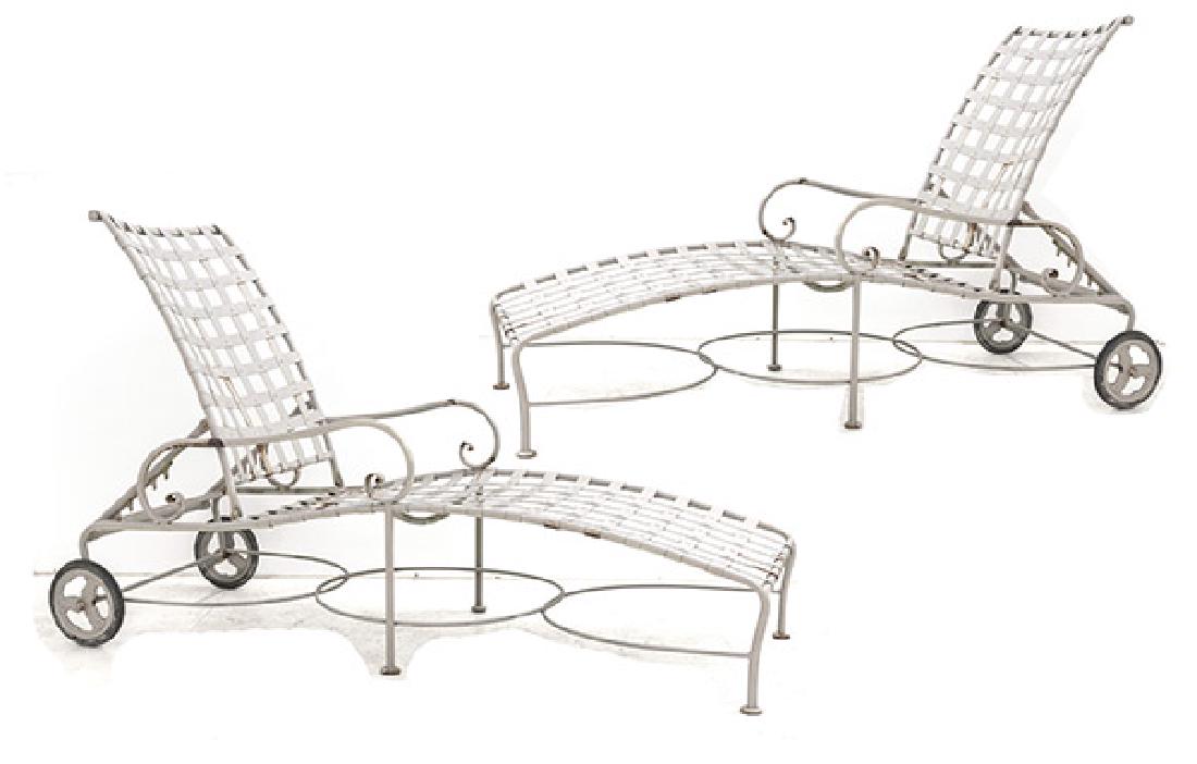 John Salterini Chaises: Adjustable chaises, pair. John Salterin Inc, USA, 1949. Cross stretchers and studded and banded straps and side supports. Enameled iron. Indoor/Outdoor cushions. 25W x 67D x 41H (highest point) 23H fo