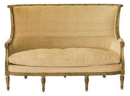 Late 18th Century Italian Sofa: Fine curved back sofa with scrolled back and arm. Outstanding carved frame with tracing of gilt, four fluted front legs with floral medallion and three back legs. Newer burlap upholstery. 