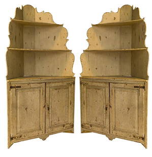 20th Century Country French Corner Cupboards: Fine pair of two part corner cupboards with top having open shelves and serpent cut out borders. Top resting on bases with cut out legs and having two doors. Original hardware and paint. 52 1/2w x