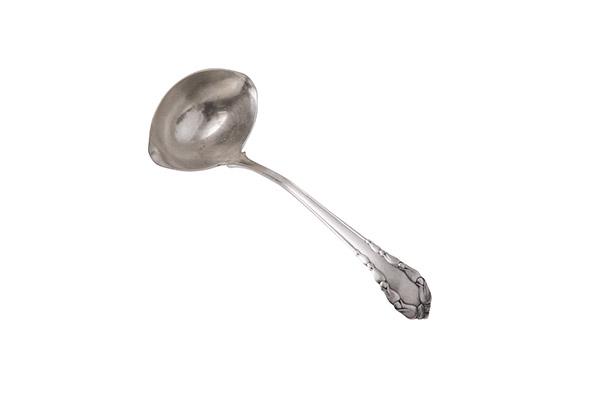 George Jensen Sterling "Lily of the Valley" cream Ladle: Sterling silver ladle, Denmark, 1915-1919, manufacture's marks to underside. Not monogrammed, 7 1/2" long. 1.93ozt.