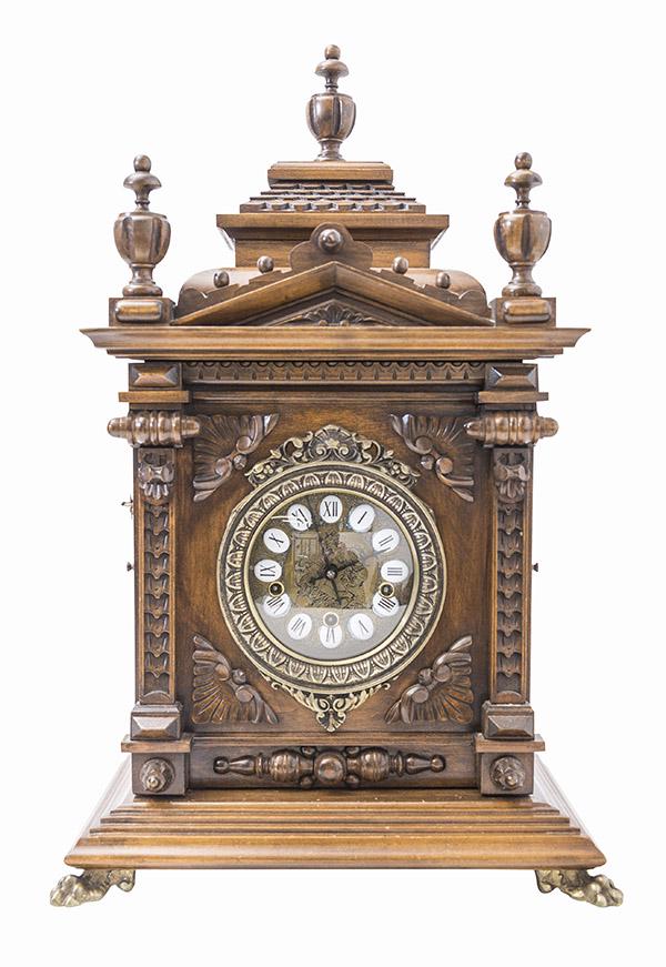 Gazo Oak "Mission Bay" Chiminy Shelf Clock: 20th Century oak clock with a 8 day T & S with eight bar strike and chime movement. The metal dial with engraved nude lady and porcelain cartouche numerals. Two glass side doors and brass paw feet. Ma