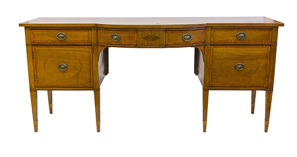 19th Century Bow Front Mahogany Sideboard: Circa 1820-1840, mahogany sideboard with satin band inlay and maple string inlay borders and interior rings. Center drawer flanked two side drawers and two lower door with orignal embossed medallion p