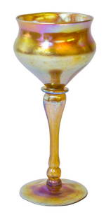 Iridescent Signed LCT Favrile Floriform Vase: Tiffany gold iridescent art glass floriform vase with stem and round base. Signed L.C.T. Favrile. Measures H 7 3/8" 3" Diameter