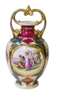 Royal Vienna Beehive Large Vase: Large Royal Vienna vase where double handles connect at the top. Decorated with gilt floral decoration on red and green background, surrounding a medallion featuring hand painted scenes signed
