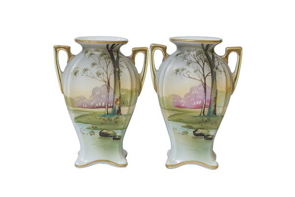 Pair of Nippon Scenic Vases Marked Green Wreath: Pair of Nippon vases with lake scene and trees. Two gold handles with flared feet. Gold decoration around the base and flared rim. Bright colors and clean surface. Marked Hand Painted Nippon with Mori