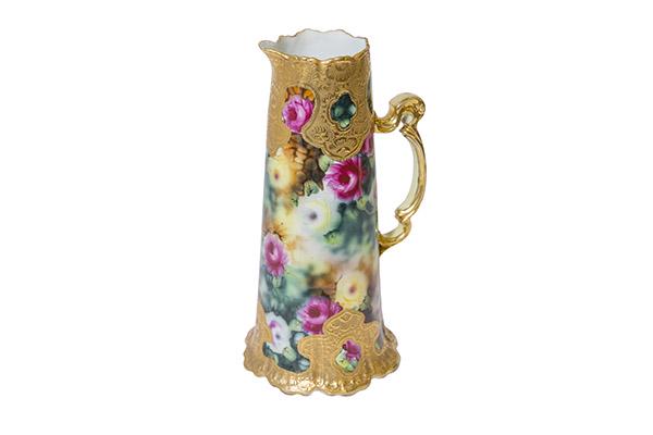 Nippon Tankard with Heavy Gold Decoration and Roses: Fine hand painted Nippon floral gilt tankard pitcher. Elaborate scrolled handle with a scalloped rim with heavy gild design with gold beads. Base repeats the same heavy gild design. Bright red, yellow