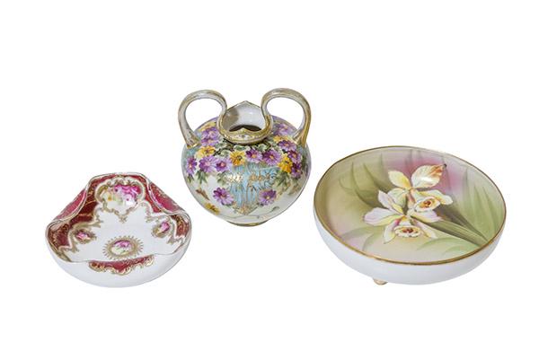 Nippon Vase, Bowl, and Candy Dish Marked: (1) Nippon vase with high arched handles, purple daisies, butterflies and gilded dÃ©cor. Marked Green Wreath. 4 1/2" W x 5 1/2" H. (1) Three footed bowl with Iris flowers and beaded design. Blue Map