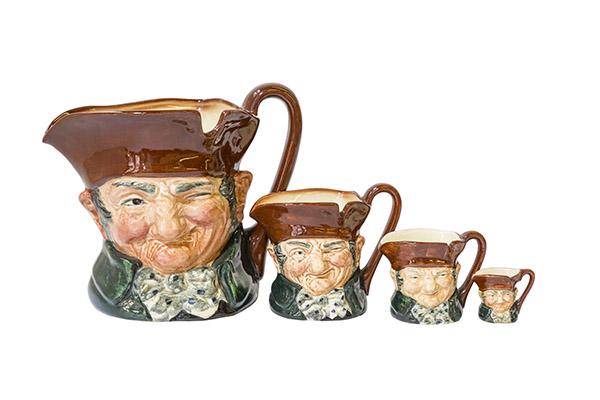 Various Sizes of Royal Doulton Toby Mugs "Old Charlie": A collection of 4 "Old Charlie" Toby Mugs graduating in size. Large, Small 3" H Miniature 2 1/4" H, Tiny 1 1/4" H. Bright colors, clean surface and beautiful detail. "A" mark on underside of all 4 pie