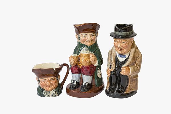 2 Royal Doulton Seated Toby Jugs & Mini Old Charlie: (1) Doulton Seated Toby Jug Old Charlie 5" H. Seated with his beer pitcher and mug. Hat as Pour Spout and Applied Handle. Hallmarked Green Royal Doulton Made in England. (1) Royal Doulton Seated Toby