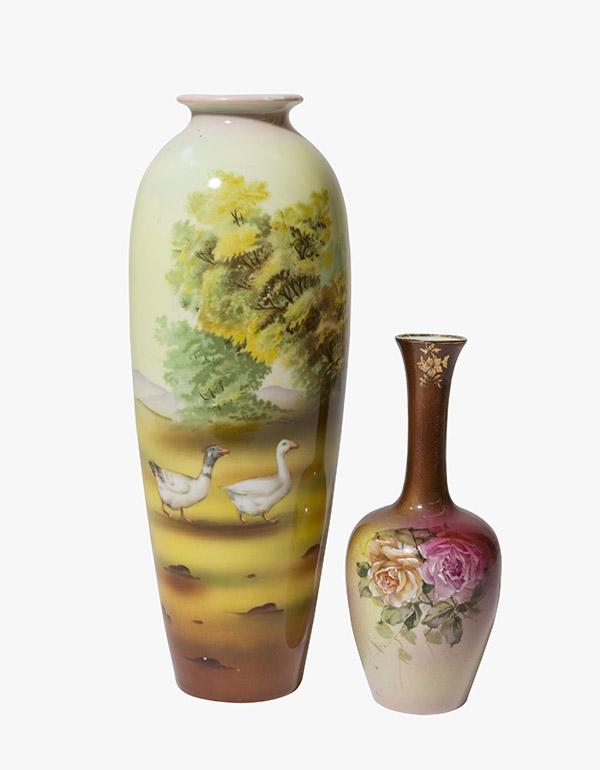Two Royal Bayreuth Tall Vases Marked: Two vases made by Royal Bayreuth Bavaria Germany. (1) 2 1/2" W x 6 1/2" H Brown and rose colored vase with yellow and pink rose dÃ©cor on green leaves. Gold gilding around the top rim. (1) Tall 3 1/