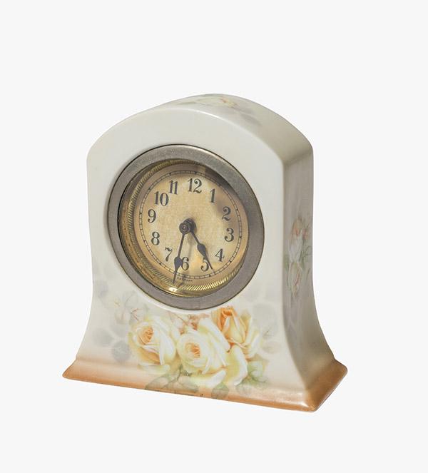 Royal Bayreuth Porcelain Clock: Hard to Find Royal Bayreuth China Clock. The face of the clock is marked Germany and has darkened from age. Decorated with Yellow and white roses around the front and back surrounded with green leaves