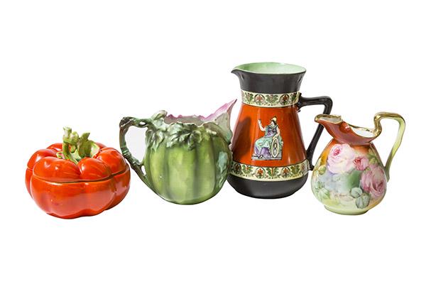 Assortment of 4 Royal Bayreuth Pitchers and Tomato: 4 Bayreuth items include (1) 3 3/4" H single handled vase decorated with Pink Roses on green background. (1) 5" Corinthian Roman ware Pitcher decorated with black rim, base and handle, orange center w