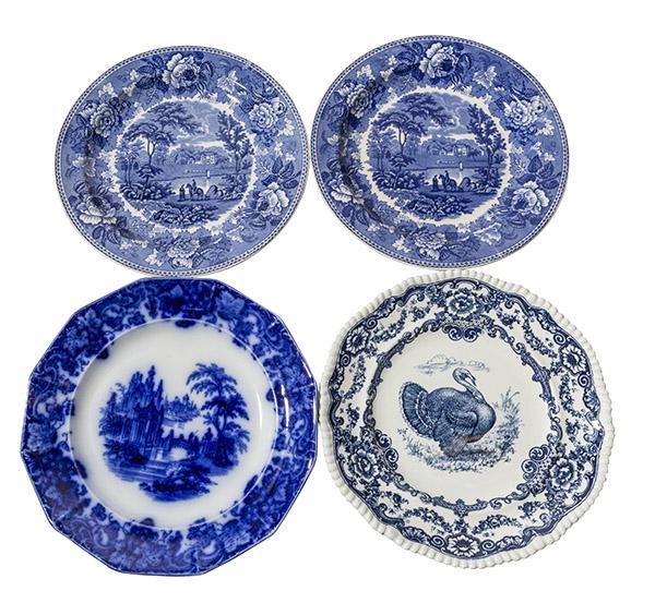 Four English Porcelain Flow Blue Plates: A grouping of 4 flow blue plates including a pair of Landscapes in England by Wedgewood, Castle Scene, and a Turkey. Detailing and bright colors. Manufactures marks to the underside. 10" Dia.