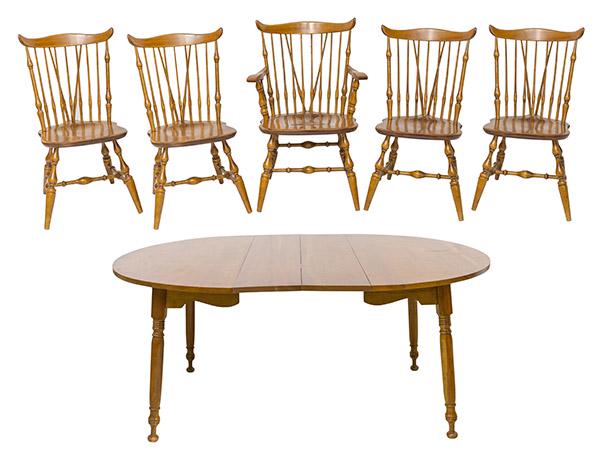 Cherry Dining Table and Spindle Chairs: Cherry table and chairs hand crafted from the Early American Shop in Cincinnati, Ohio by W.B. Meier. Round Dining Table with two leaves on turned legs. Set of four spindle back dining chairs and one e