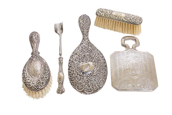 Assembled Sterling Silver Mirrors Plus: Repousse mirror with embossed scrolling leaves, Queen Anne vanity mirror, sterling repousse brush, hand held brush and sterling handle bone marrow spoon. Four monogrammed. 4w x 10h