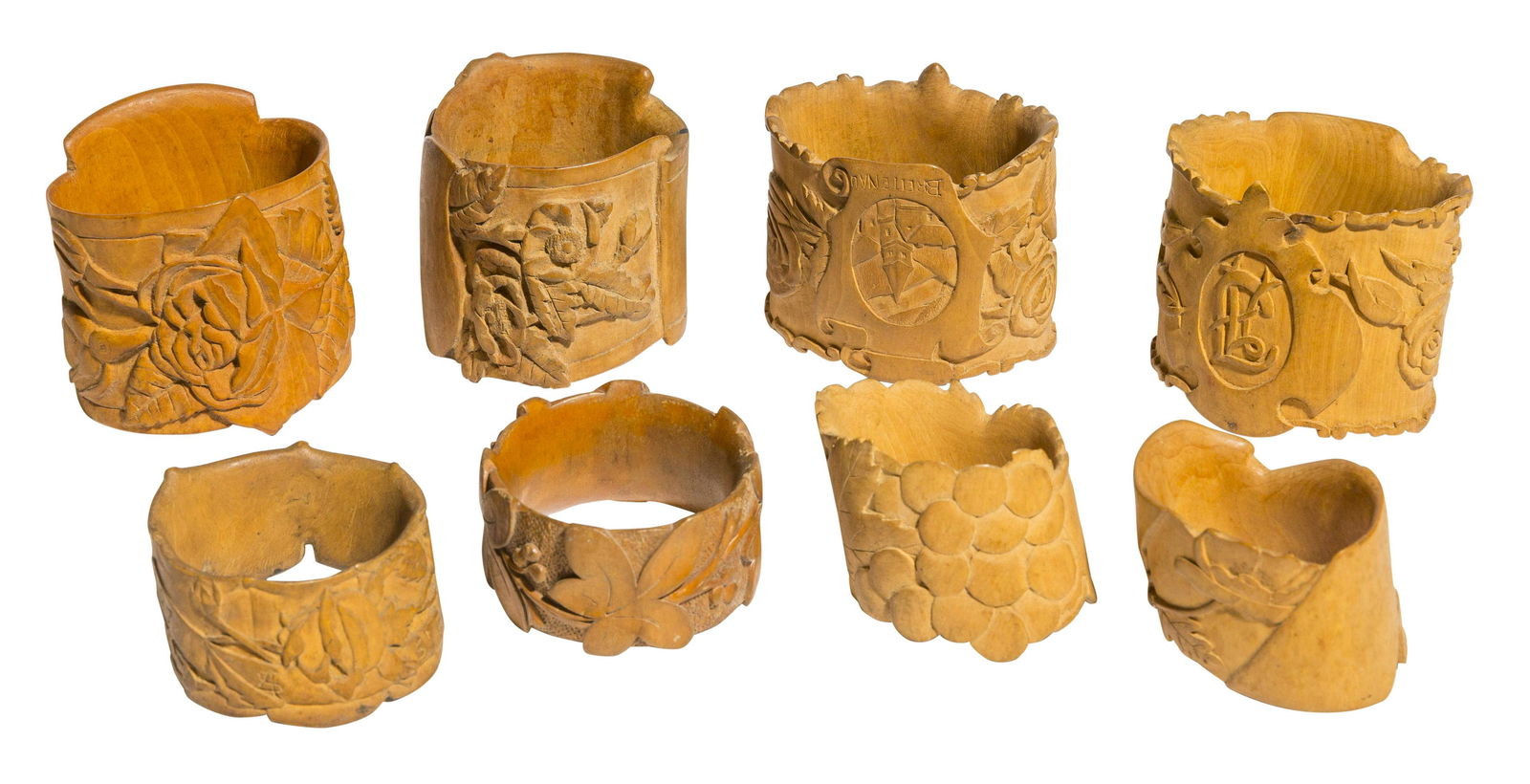 Set of Signed Carved Napkin Rings: Carved floral pattern, set of eight. 2 1/4 dia x 2 1/4h. Signature to interior, dated 1976.