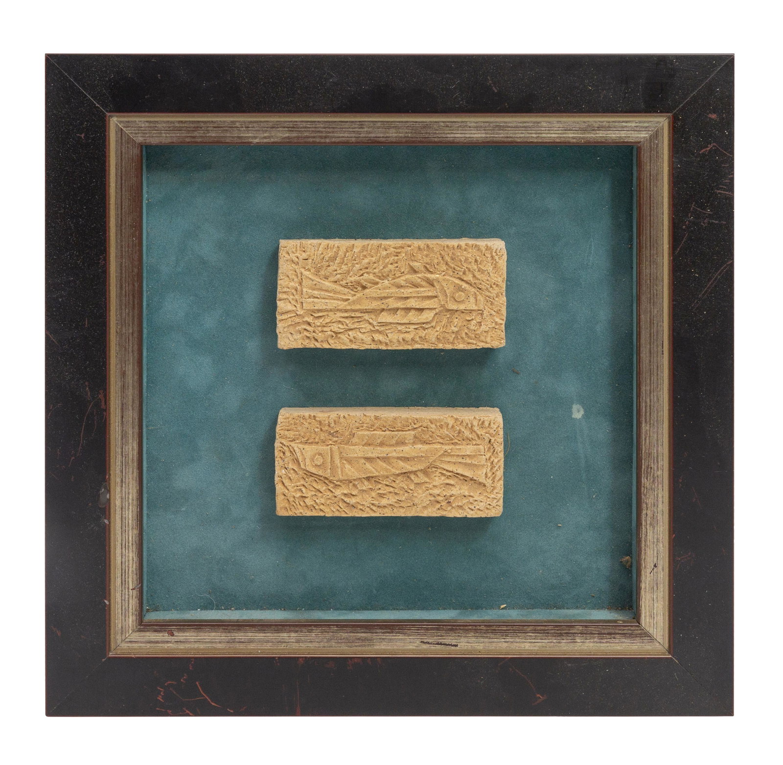Antique Thai Stone Fragments: Early 20th century, (2) stone fragments mounted to seude and ebony frame. Fragments- 3.75w x .625d x 2h