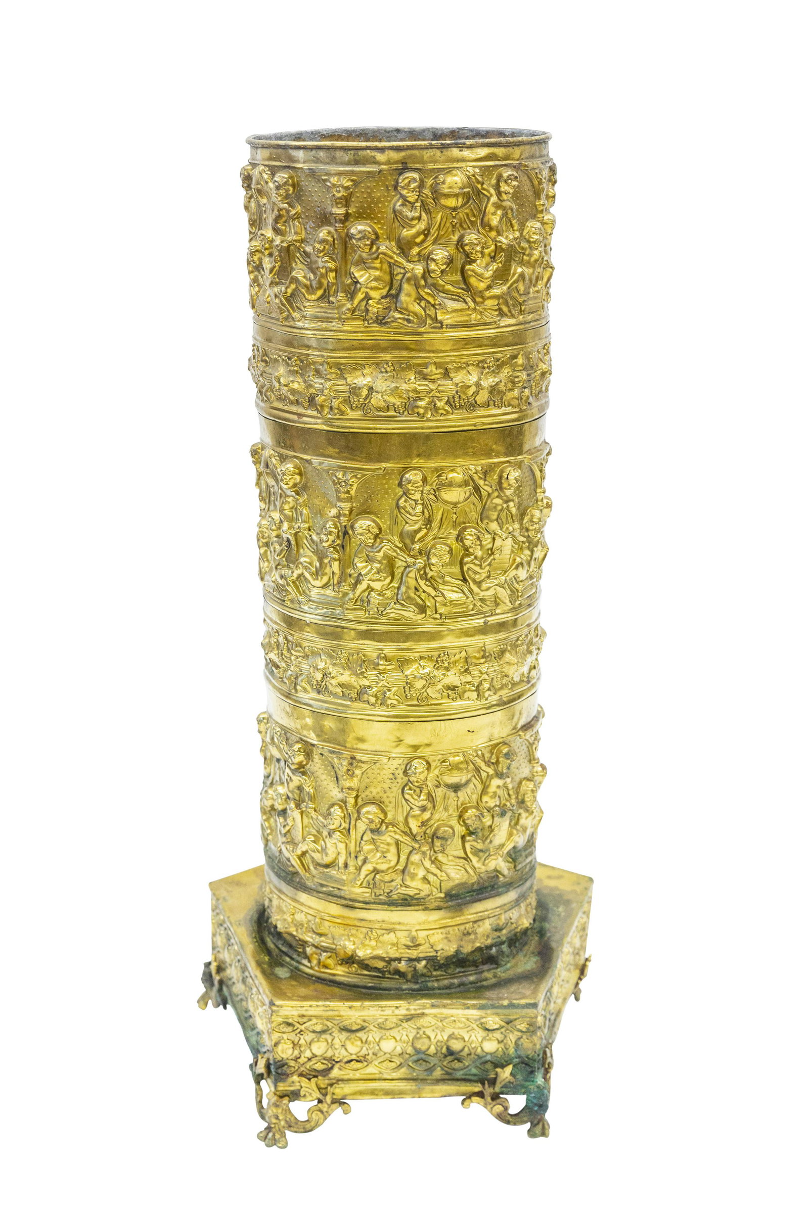 Brass Embossed Putti Umbrella Holder: Brass cylinder umbrella holder with embossed putti's and globes on raised footed pentagon base. 10w x 11w x 27.5h