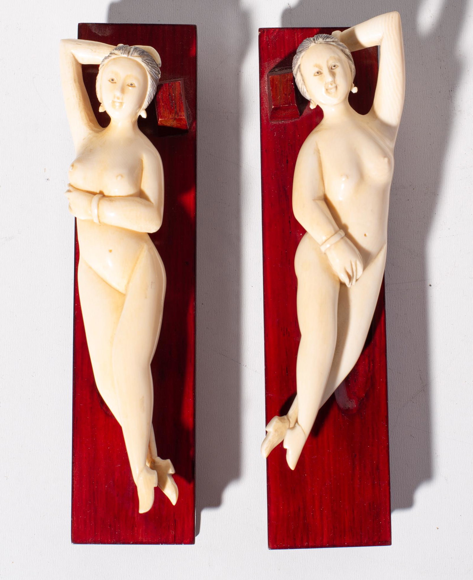 Japanese carved reclining nudes on stands: 2 intricately carved reclining nude ladies resting on teak stands. 2w x 6.75d x 2h