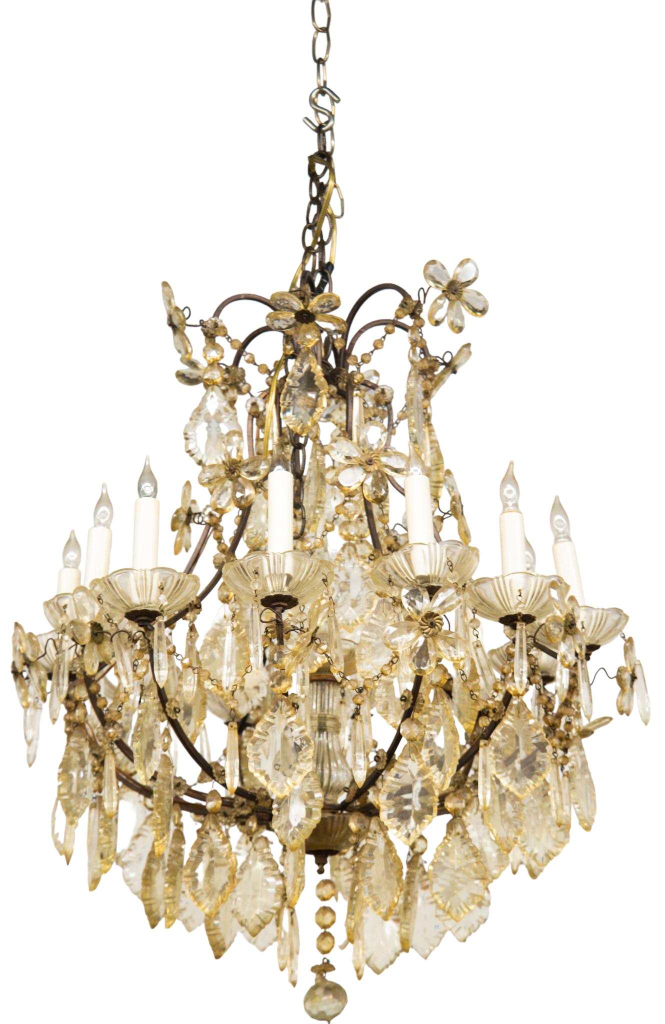 Gilded Bronze and Baccarat (Attr.) Crystal Chandelier: 1920's crystal chandelier with twelve arms and various crystal prisms and flowers. 23 diameter x 27h.