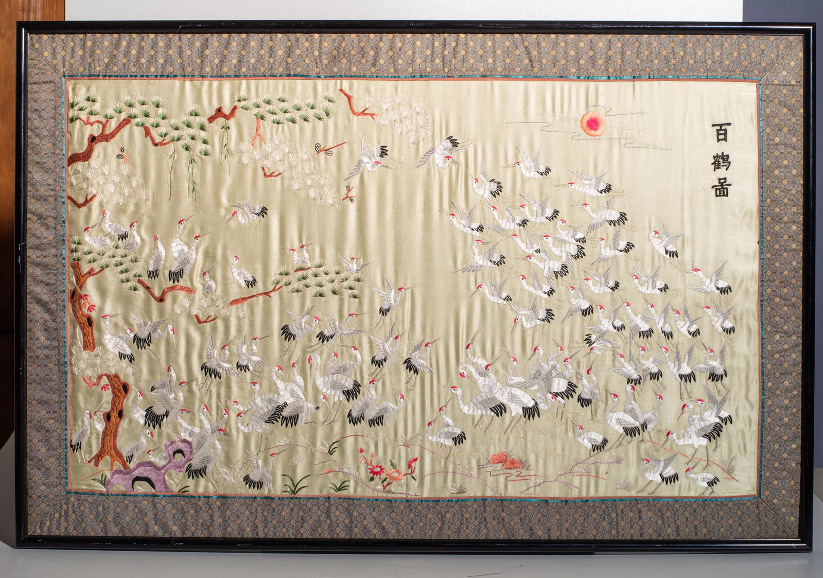 Japanese Silk Embroidery "Flock of Cranes": Hand stitched silk embroidery decorated with cranes and trees. Signed upper left. 20 x 33, Frame- 25 x 38.