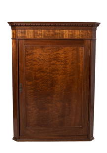 19th Century Mahogany Hanging Corner Cabinet: Hanging Corner Cabinet. Circa 1880 having thumb molded top over dentil molding above a single door and molded base. Two interior tombstone cut shelves. 29w x 16d x 38 1/2h.