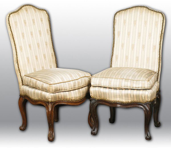 Pair Louis XV Walnut Slipper Chairs: Circa 1880 with carved cabriole legs, scrolled skirt, covered in silk upholstery Size: 17 x 17 x 34h, seat 16h From the Estate of Henry S. Paulin