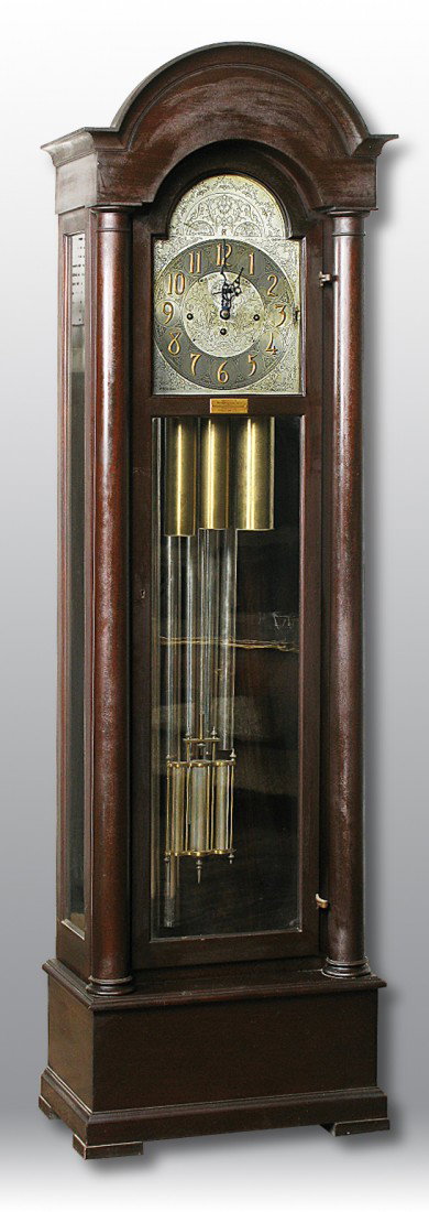 Herschede Mahogany Tall Case Clock: Time, strike and chime 8-day weight driven brass movement with 5 tubes, alekeled engraved dial, second hand above center. Case in original finish with full columns, bracket base, domed top, brass pres