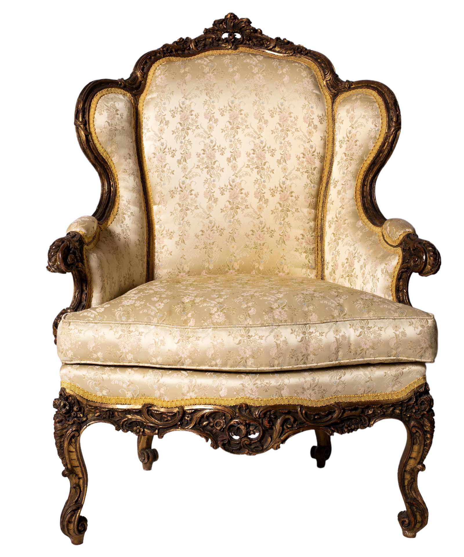 19th Century Louis XV Style Carved Bergere: Armchair. Louis XV style in fruitwood with yellow satin damask with woven rose pattern upholstery and cushion, back with floral carved surround and scrolled floral carved arms, apron and cabriole legs