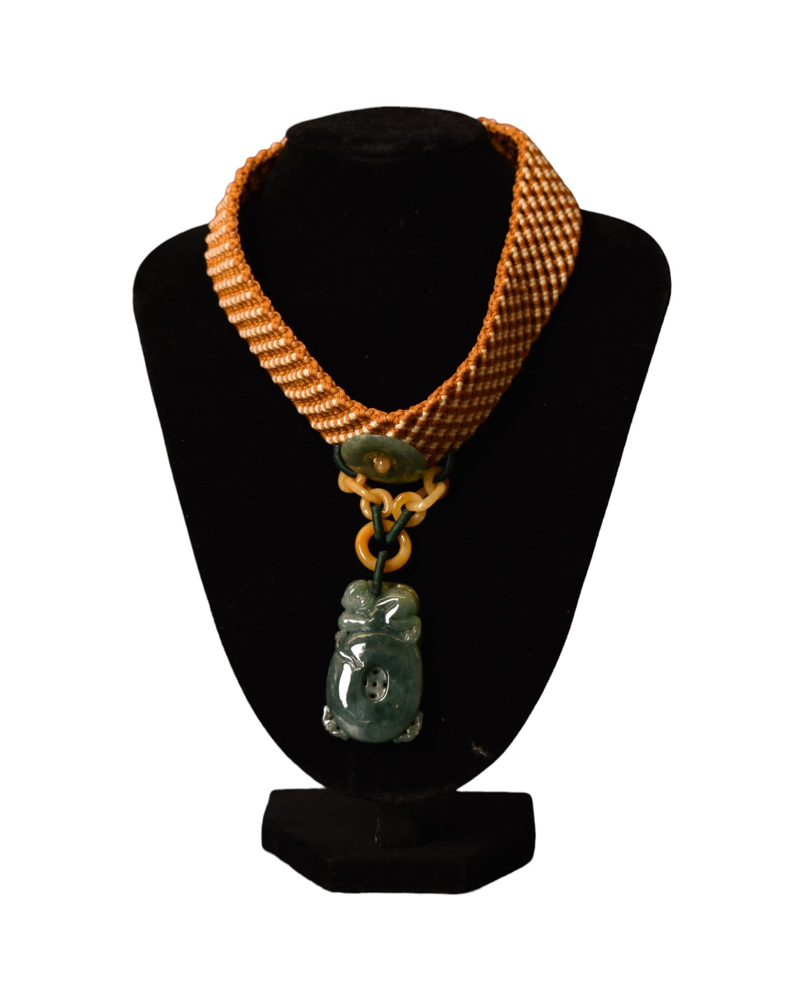 Jadeite Pendant on woven Rope: Necklace with jadeite pendant with figure on horse hanging from stone rings. Pendant 1w x 1 1/2h.