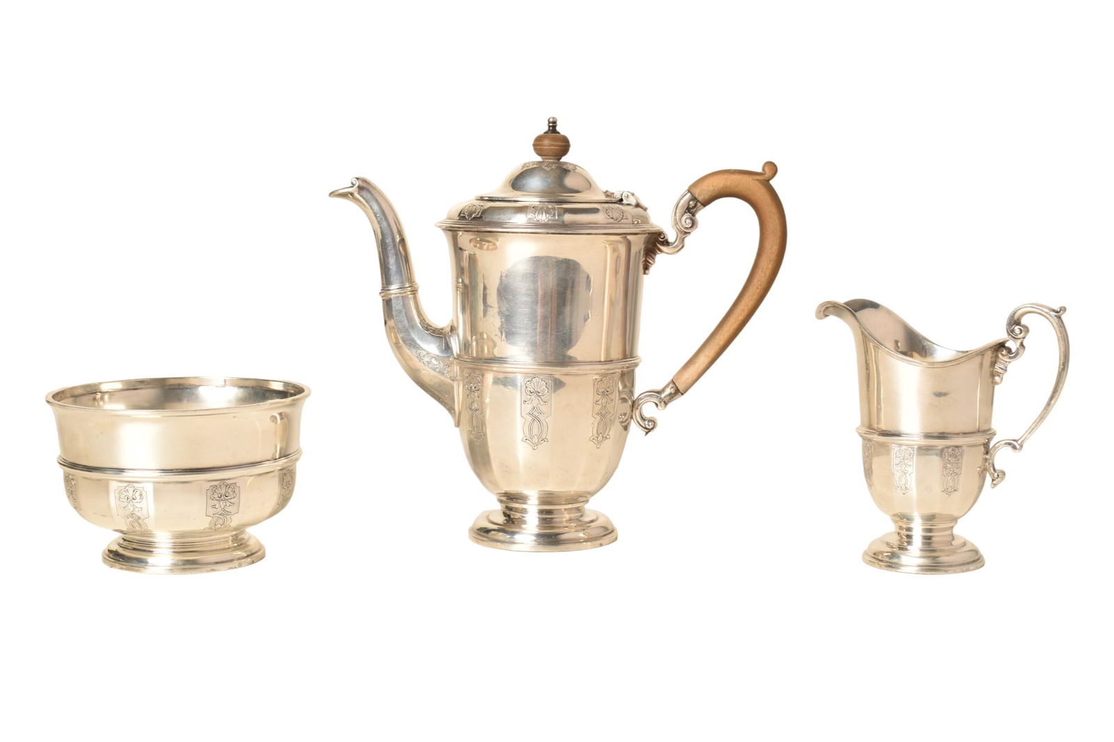 Charles & Richard Comyns Sterling Silver Tea Set: Charles & Richard Comyns Sterling Silver Tea Set. 3-piece set. Marked C &R and made in England. Engraved with shells and decorations. Teapot with wooden handle 8 3/4" x 8". Creamer 4 3/4". Sugar 4 1/2