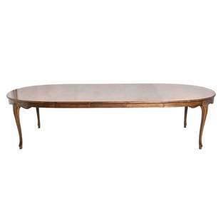 Baker Furniture French Country Dining Table: Baker Furniture French Country Dining Table. Oak dining table, oval with scalloped aprons resting on cabriole legs terminating to French feet. Three - 18" leaves. Manufacture's marks to underside.