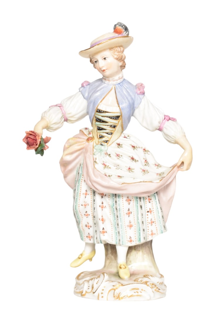 Meissen Porcelain Flower Lady: Porcelain flower lady wearing ornate dress holding a rose. Bears crossed sword mark to underside and incised numbers 20/62. 3-1/2" W x 2" D x 5-1/2" H