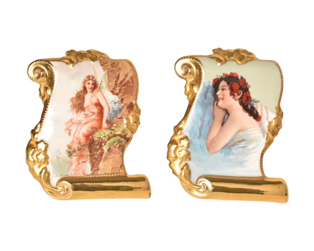German Royal Beehive Porcelain Bookends: Porcelain bookends with gilded scrolled frames. Hand decorated with ornate ladies. Manufacturer's mark to verso. 4-1/4" W x 2-1/2" D x 4-1/2" H.